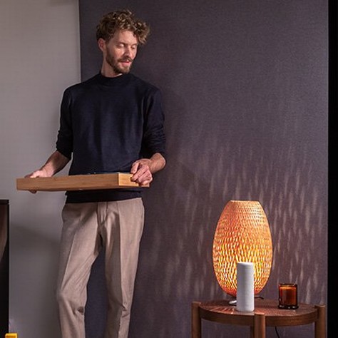 man operating blinds from a smart speaker