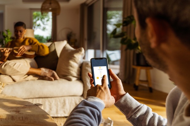 Somfy - on couch with smartphone
